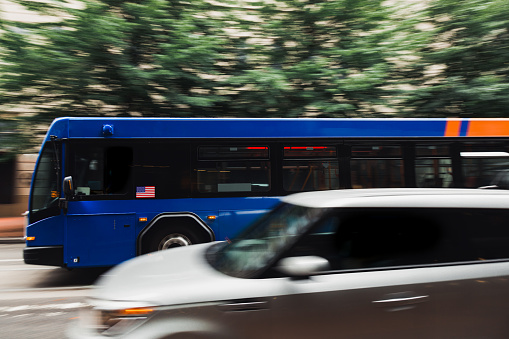 Image of a public city bus in motion. Shot in downtown Portland Oregon, panning effect used to show bus is in motion.