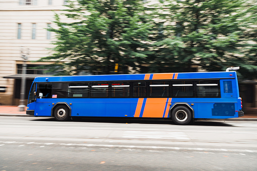 Image of a public city bus in motion. Shot in downtown Portland Oregon, panning effect used to show bus is in motion.