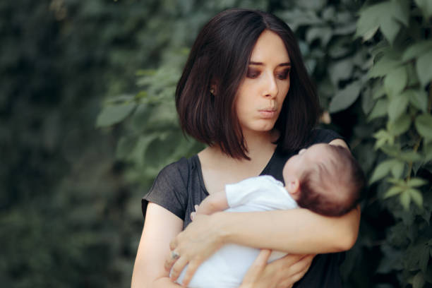 istock Mother Singing to Her Baby Outdoors in the Park 1265372802