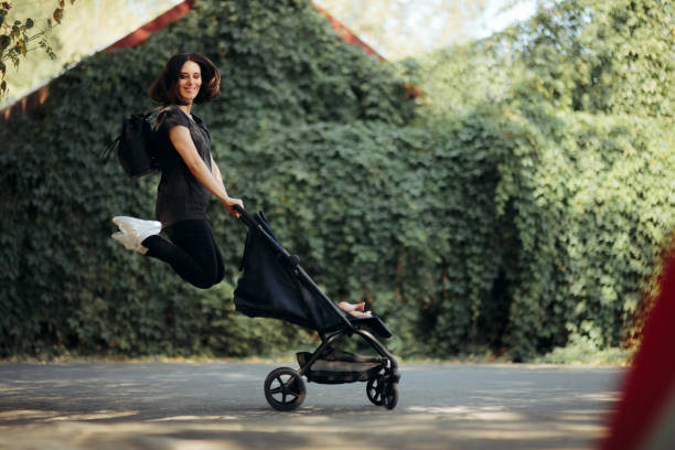 happy mother pushing baby stroller jumping with joy - mother exercising baby dieting imagens e fotografias de stock