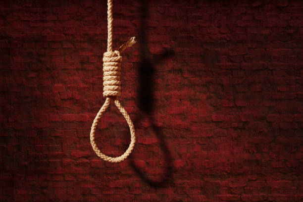 istock suicide concept. noose with shadow on dark wall background 1265399964