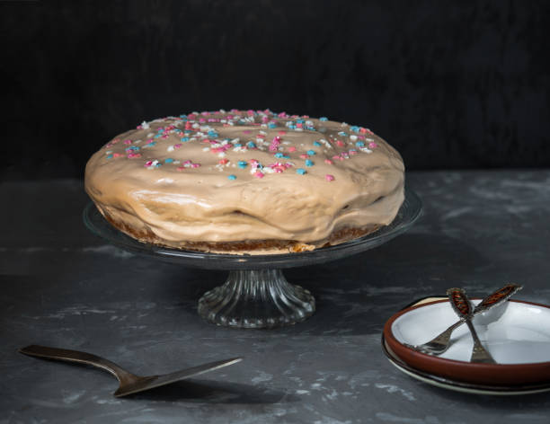istock Cake on a strawberry box and dessert saucers with forks, a spatula for serving a tornado on a gray background 1265408048