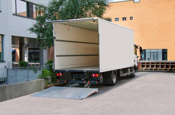 istock White empty delivery truck with tailgate open in front of an office building. 1265418802