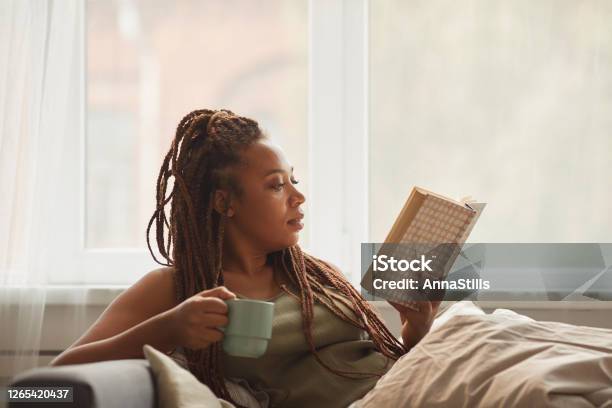 Woman Reading A Book Stock Photo - Download Image Now - Reading, Book, Relaxation