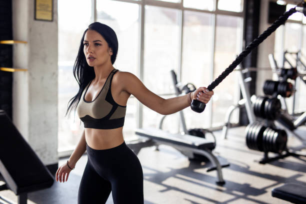 istock Fit athletic woman pull and exercise on machine in gym to make a better body shape 1265421520