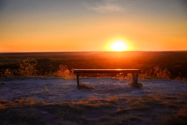 istock A bench on a mountain in the setting rays of the sun 1265422048