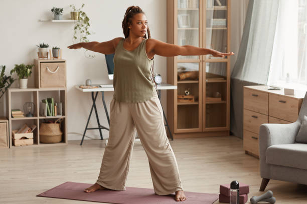 istock Woman exercising at home 1265423670