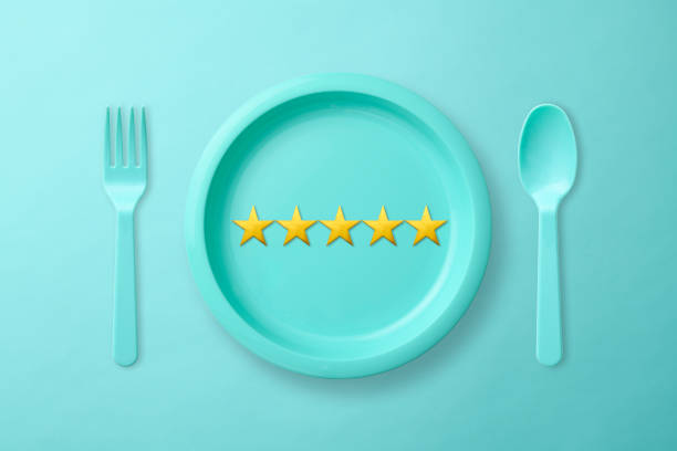 istock Blue plastic cutlery with five stars on light blue background. 1265428092