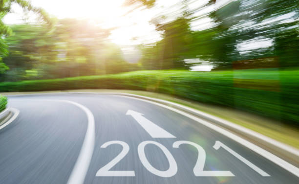 istock Empty asphalt road with Number 2021 in motion blur 1265428148