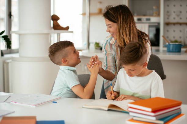 istock Mother helping children with they homework. 1265428261