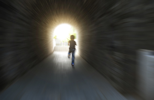 Little boy running through the tunnel