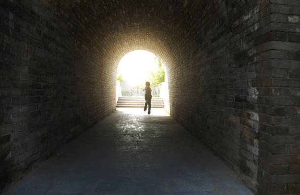 istock Little boy running through the tunnel 1265429722