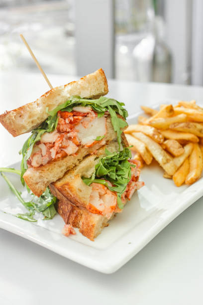 Lobster Grilled Cheese Lobster Grilled Cheese with a side of french fries melting tuna cheese toast stock pictures, royalty-free photos & images