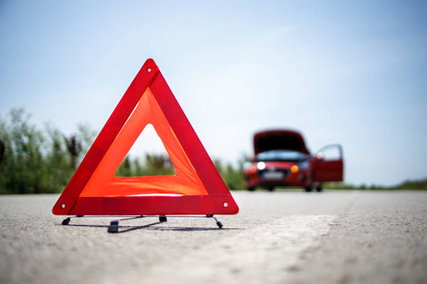 Portable warning triangle on the street Warning triangle placed on the road engine failure stock pictures, royalty-free photos & images