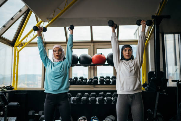 istock Muslim women working out with dumbbells 1265435213