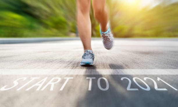 istock Woman legs running on asphalt road 1265435307