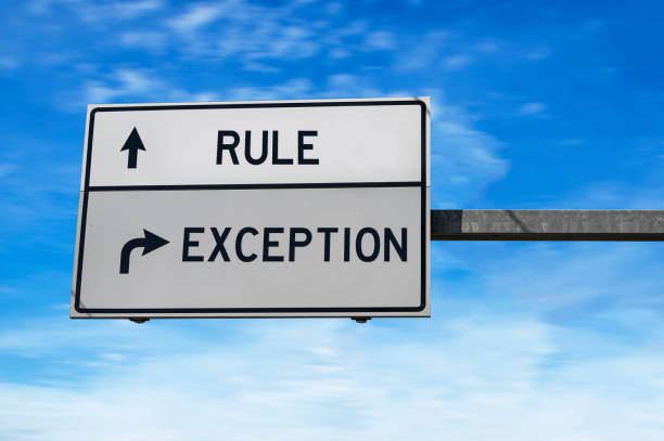 Rule versus exception. White two street signs with arrow on metal pole. Directional road. Crossroads Road Sign, Two Arrow. Blue sky background. stock photo