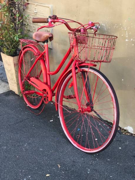 istock Vintage red bicycle and basket leaning against a concrete wall 1265435667