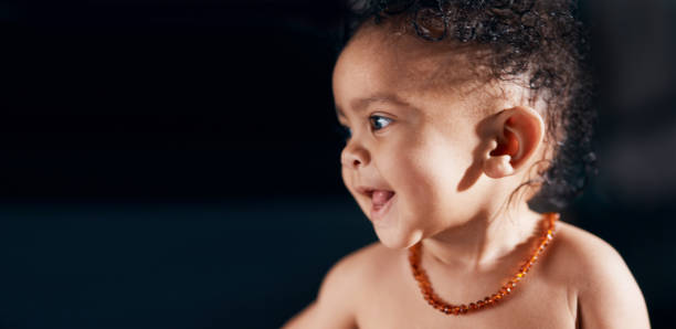 Studio shot of an adorable baby boy against a black background