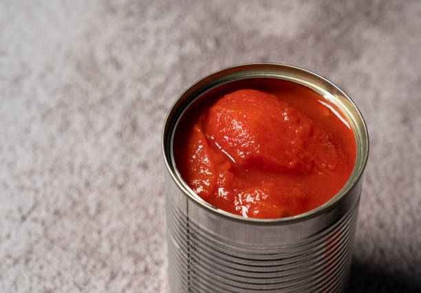 istock Whole tomato cans on a stone background 1265440636