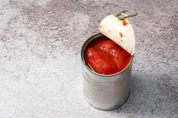 istock Whole tomato cans on a stone background 1265440696