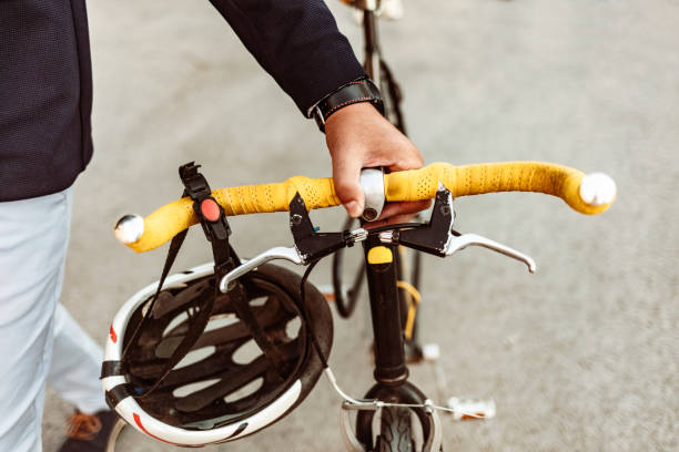 Photo of businessman pushing a bicycle while going to work.