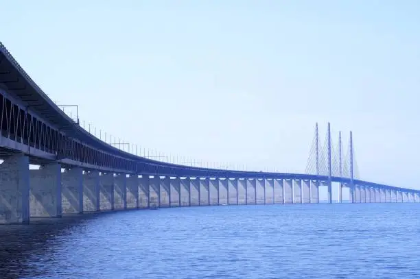 Soft blue weather over the Öresundsbron, also spelled Oresund or Oeresund bridge between Sweden and Denmark, view from Malmö, Sweden shore. The bridge is 7.8 km long. It was inaugurated 1999. The architect is Georg Rotne.
