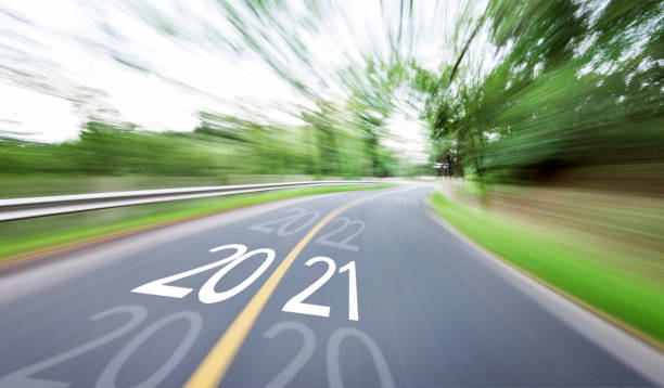 istock Blurred road with number 2020 cange 2021 1265453259