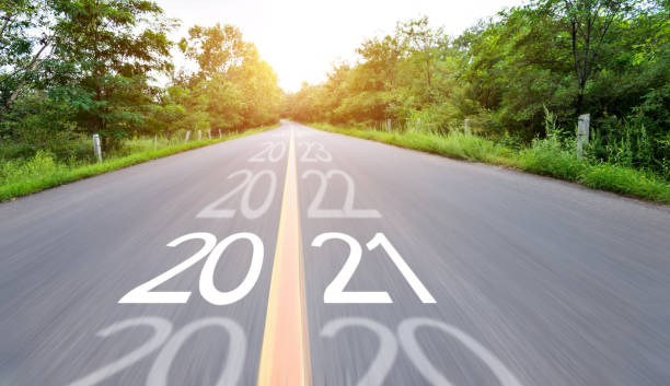 istock Blurred road with number 2020 cange 2021 1265453260