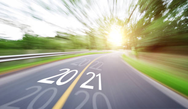 istock Blurred road with number 2020 cange 2021 1265454331