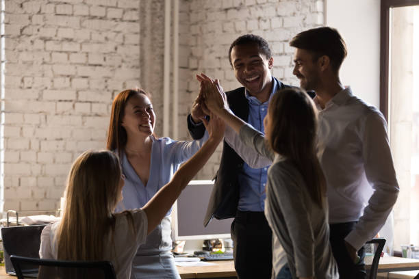 istock Diverse employees team giving high five, celebrating business success 1265464687
