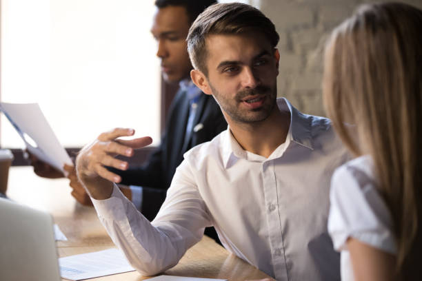 istock Friendly businessman mentor training intern, colleagues working together 1265464714
