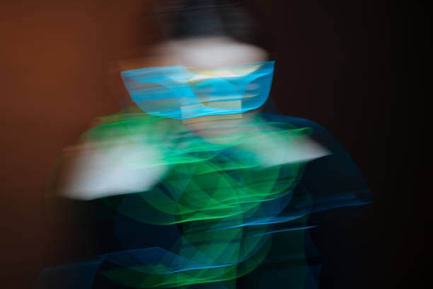 istock Attractive brunette in neon wires and glowing masquerade mask 1265465208