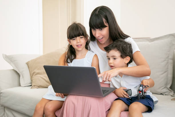 istock Positive excited mother embracing two kids 1265466109