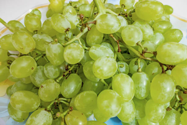 istock close up bunches of white grapes on a plate 1265468095