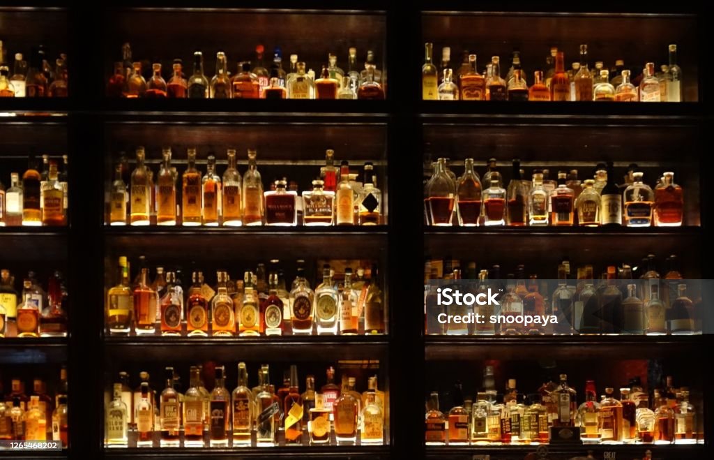 Stylish wall full of spirit bottles in a bar Bar - Drink Establishment Stock Photo