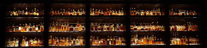Stylish wall full of spirit bottles in a bar