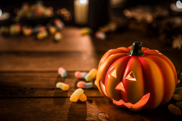 istock Halloween ornate: Jack-o-Lantern pumpkin on a rustic wooden table 1265468207