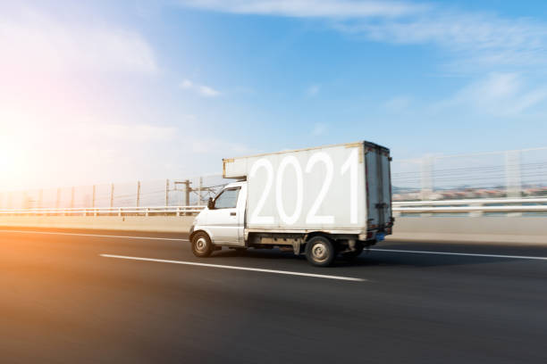 istock Number 2021 on delivery van driving on highway 1265469506
