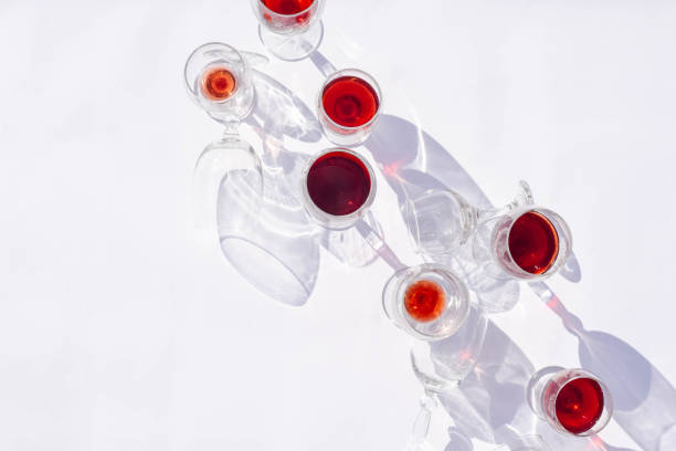 Wine of different varieties in glasses on a white background. Fashionable hard shadows from glasses.