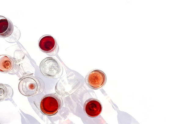 Wine of different varieties in glasses on a white background. Fashionable hard shadows from glasses.