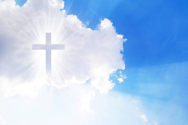 istock Christian cross appears bright in the sky 1265471684
