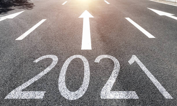 istock Number 2021 and arrow signs on asphalt road 1265472325