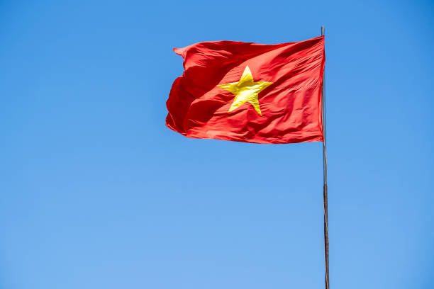 istock Red Vietnam flag against the blue sky 1265472938