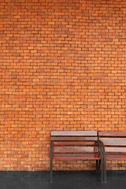 brown wood bench with red brick cement wall architecture background