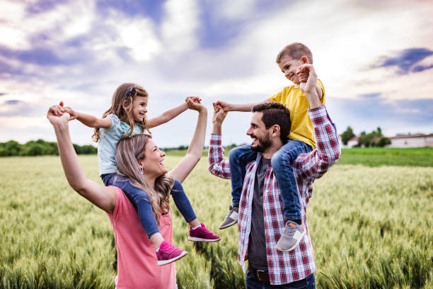 istock Young happy family enjoying nature 1265477230