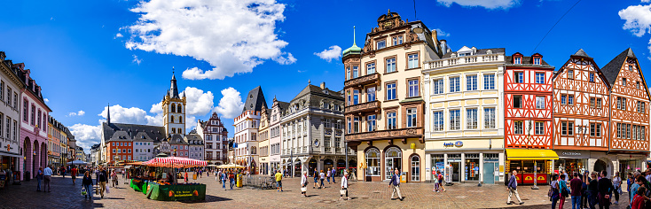 Trier, Germany - July 7: historic buildings and tourists at the famous old town of Trier in Germany on July 7, 2020