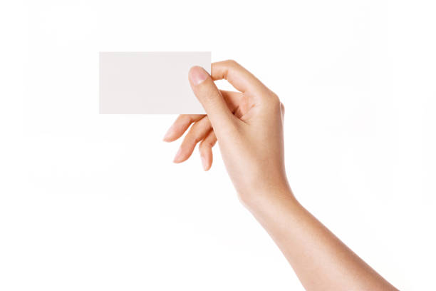istock woman hand holding a blank namecard horizontal isolated on white. 1265498184