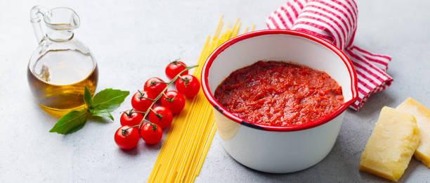 sauce tomate traditionnelle dans une casserole avec des pâtes spaghetti. fond gris. fermez-vous. - macaroni cheese food staple casserole photos et images de collection