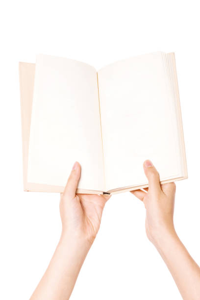 istock woman hand holding book spread a isolated on white. 1265499274